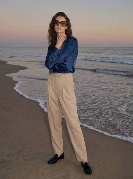 Model on beach in blue shirt